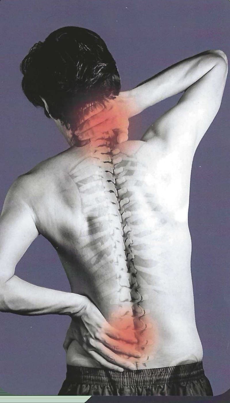 A person holding their lower back and neck, with an illustrated spine overlaid and the neck and lower back highlighted in red to show where pain is felt